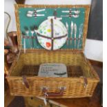 Wicker picnic basket with contents