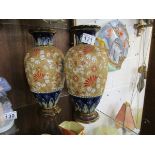 Pair of Doulton vases with restoration