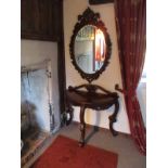 Ornate carved mahogany console table with matching mirror