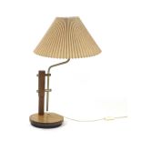 A 1970's turned beech table lamp with a stainless steel bent and adjustable shaft on a circular