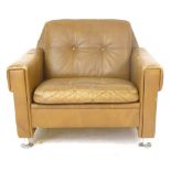 A Skippers Mobler tan leather and button upholstered lounge armchair on chromed feet