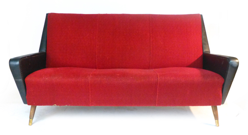 A 1950's G-Plan type black vinyl and red upholstered three seater sofa on teak tapering feet with