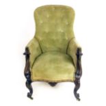 A Victorian Rosewood and green velvet button back upholstered salon chair,