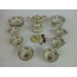 A brown and white cottage decorated dolls tea set comprising of tea pot,