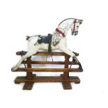 A early Victorian white painted child's rocking horse on painted wooded plinth,