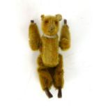 A mechanical wind up late Victorian bear with gold faux fur, button eyes wooden hands and feet,