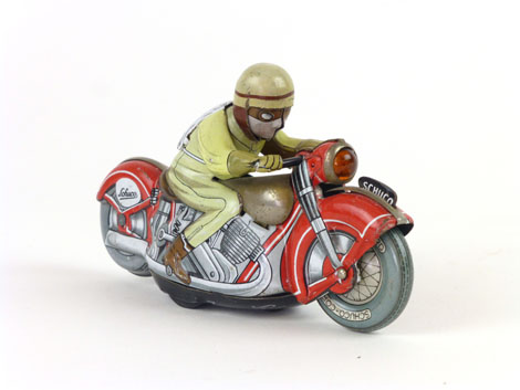 A Shuco tinplate wind up motorbike racer with red framed bike,