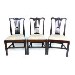 A set of three mid 18th century mahogany dining chairs,