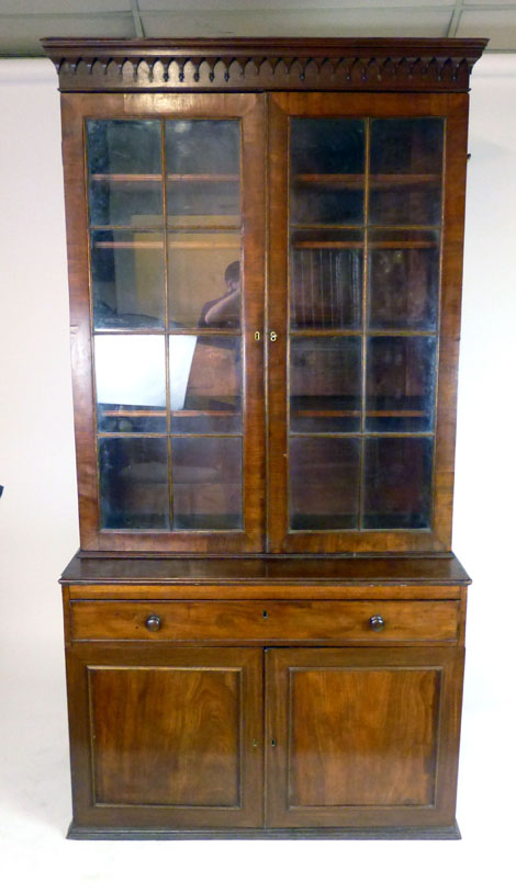 An 18th century mahogany astragal glazed book case, the double doors revealing adjustable shelves,