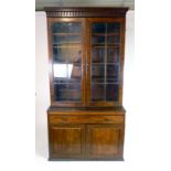 An 18th century mahogany astragal glazed book case, the double doors revealing adjustable shelves,