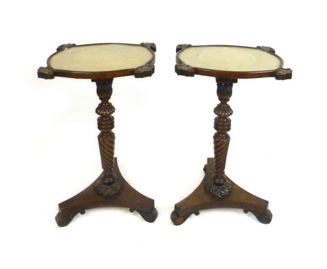 A pair of William IV mahogany occasional tables with lace work under glass tops on carved gadrooned