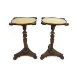 A pair of William IV mahogany occasional tables with lace work under glass tops on carved gadrooned