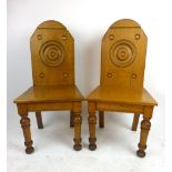 A pair of Victorian oak hall chairs, the backs with turned rounded details on turned front legs, h.