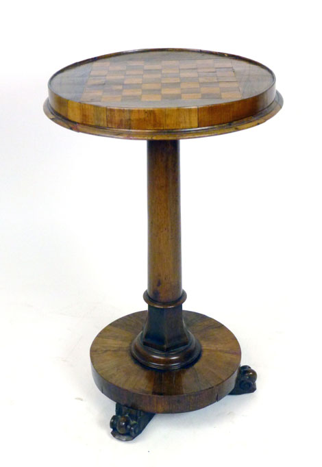 A William IV rosewood games table with satinwood and rosewood chess board top on a turned and