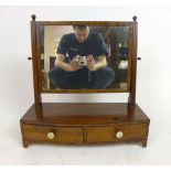 A Regency mahogany and ebonised line inlay bow fronted toilet mirror,