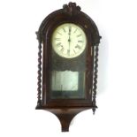 A 19th century walnut cased eight day clock the enameled face with Roman numerals and pierced hands.
