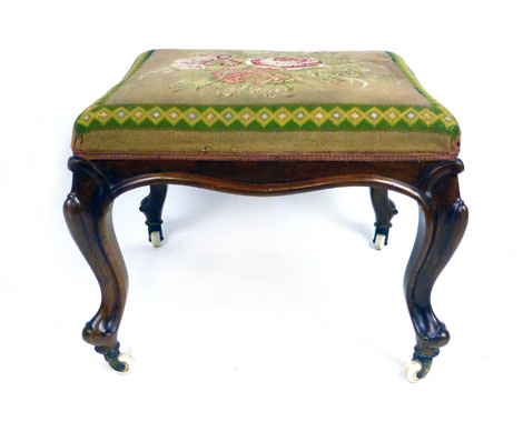 A Victorian walnut and floral tapestry upholstered stool,