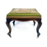 A Victorian walnut and floral tapestry upholstered stool,
