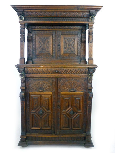 A Victorian Elizabethan Revival oak court cupboard, profusely carved with marks,