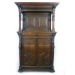 A Victorian Elizabethan Revival oak court cupboard, profusely carved with marks,