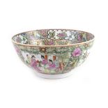A 19th century Chinese famille verte bowl decorated with a group of figures exiting a house,