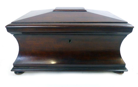 A Victorian mahogany concave sarcophagus tea caddy with fitted interior,