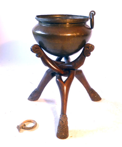 A 19th century Indian brass bowl on a wooden stand,