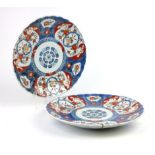 A late 19th/early 20th century Chinese dish decorated in the Imari palette within a scallop border,