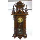 An early 20th century Vienna style beech wall clock, the face with Roman numerals and pierced hands,