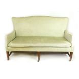 An Edwardian Georgian-style mahogany and green cut fabric three seater sofa,