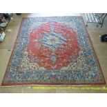 A hand woven Eastern rug, the multi lined boarder enclosing a red ground with central medallion, l.