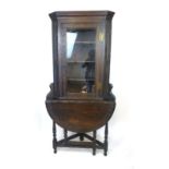 A late Victorian oak glazed corner cupboard on credence style table stand, h. 178 cm, w. 86 cm, max.