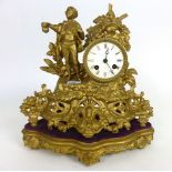 A 19th century Rococo style gilt metal eight day mantle clock with a figure of a gentleman