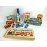 A collection of tinplate and other toys to include a tinplate Russian train set, cars, saloon cars,