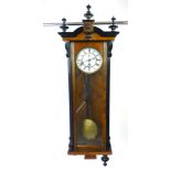 An early 20th century parcel ebonised walnut Vienna style wall clock,