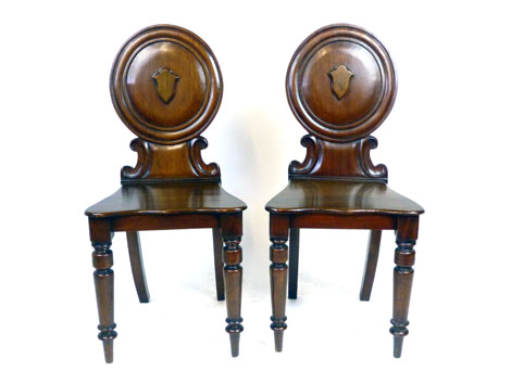 A pair of Victorian mahogany hall chairs,