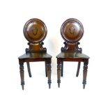 A pair of Victorian mahogany hall chairs,