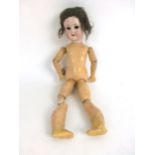 A Schoenau and Hoffmeister German bisque headed doll, stamped 1909 one and a half to back of neck,