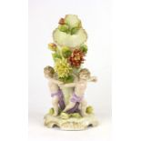 A 19th century Sitzendorf figural vase surrounded by three cherubs with outstretched arms, h.