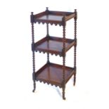 A Regency mahogany three tier whatnot, with bobbin turned supports and arched aprons to each shelf,