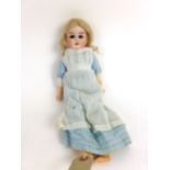 An early 20th century bisque headed doll marked 9/0 with wood and composition body,