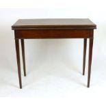 A late 18th century mahogany fold over tea table with double gate action on square tapering legs, h.
