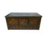 A reproduction Tibetan painted hutch cupboard with florally painted central door,