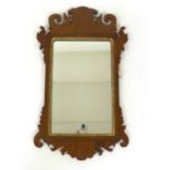 A Georgian mahogany wall mirror. h. 59 cm, w.