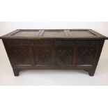 A late 17th century oak coffer with a three panel top lifting to reveal a vacant interior over a