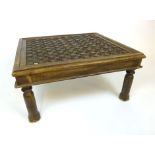 A 20TH century and earlier Eastern carved topped coffee table on turned legs, h. 36 cm, w. 74 cm, d.