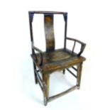 A (?) 19th century Chinese elm open arm chair with the Chinese character for longevity carved into