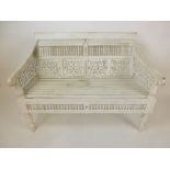 A reproduction Eastern white painted bench with spindles and pierced panels on turned legs, h.