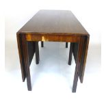 A Georgian mahogany drop leaf dining table with double gate action,