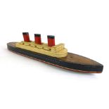 An early 20th century painted wooden pull along toy in the form of The Queen Mary steam ship,